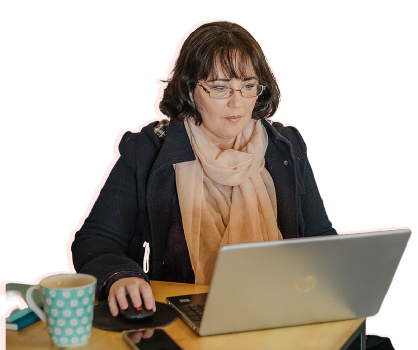Melanie sitting with her laptop concentrating.